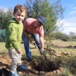 dad and son planting a tree