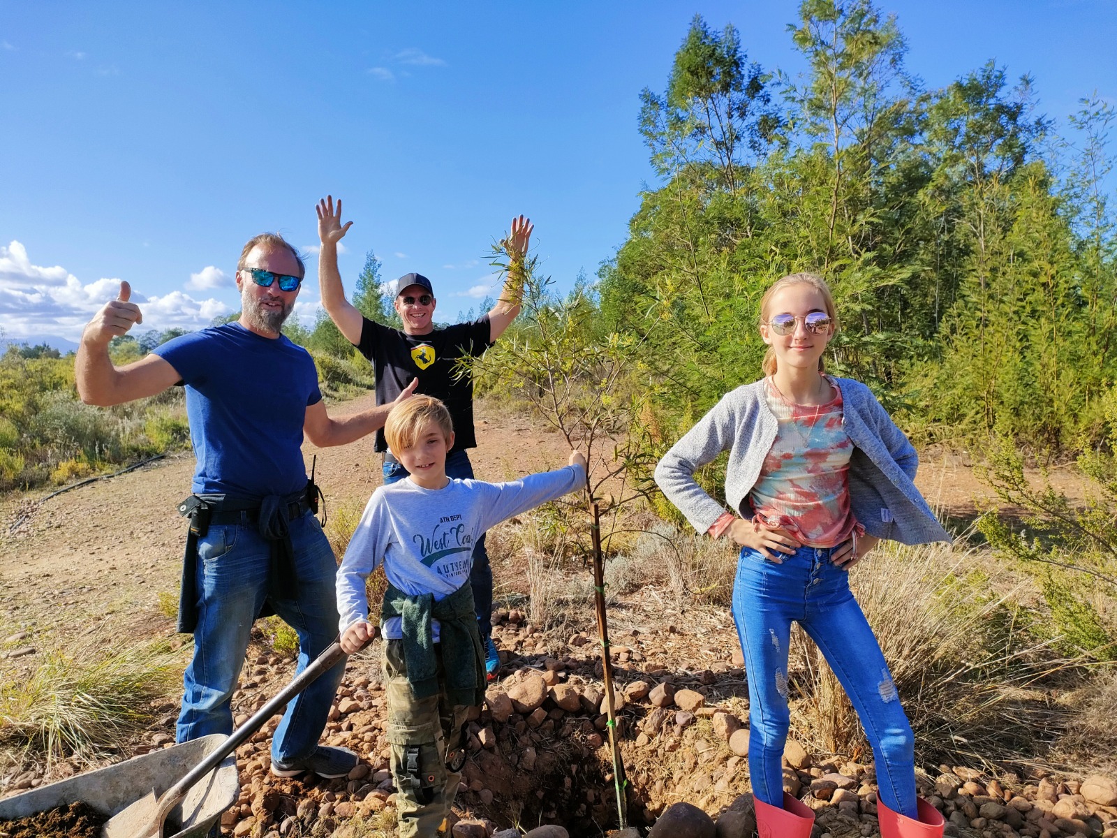 people planting a tree at The GAIA Sanctuary